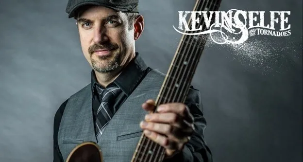 A man holding a guitar in front of the name kevin.